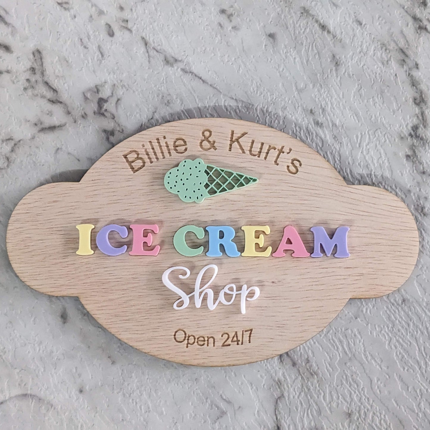 Custom Wooden sign for 'pretend play kitchen Ice Cream Shop' on a marble surface
