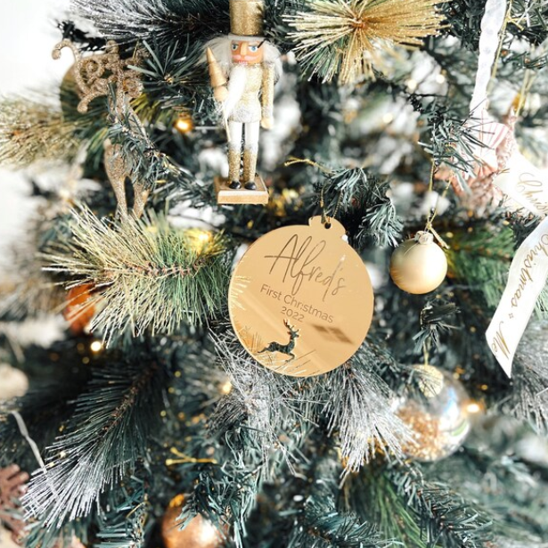 Reindeer Decorative Christmas tree with gold ornament and 'Alfred's First Christmas 2022' tag.