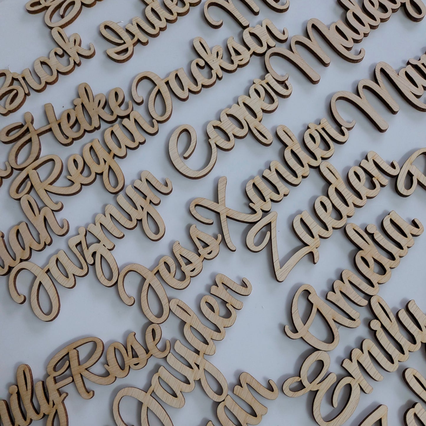Individual guest name cutouts. wooden place names for a wedding or event table.