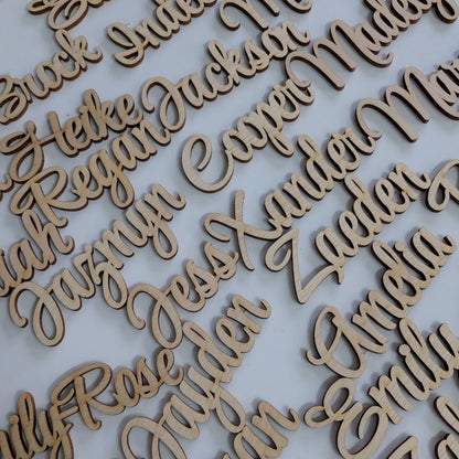 Individual guest name cutouts. wooden place names for a wedding or event table.