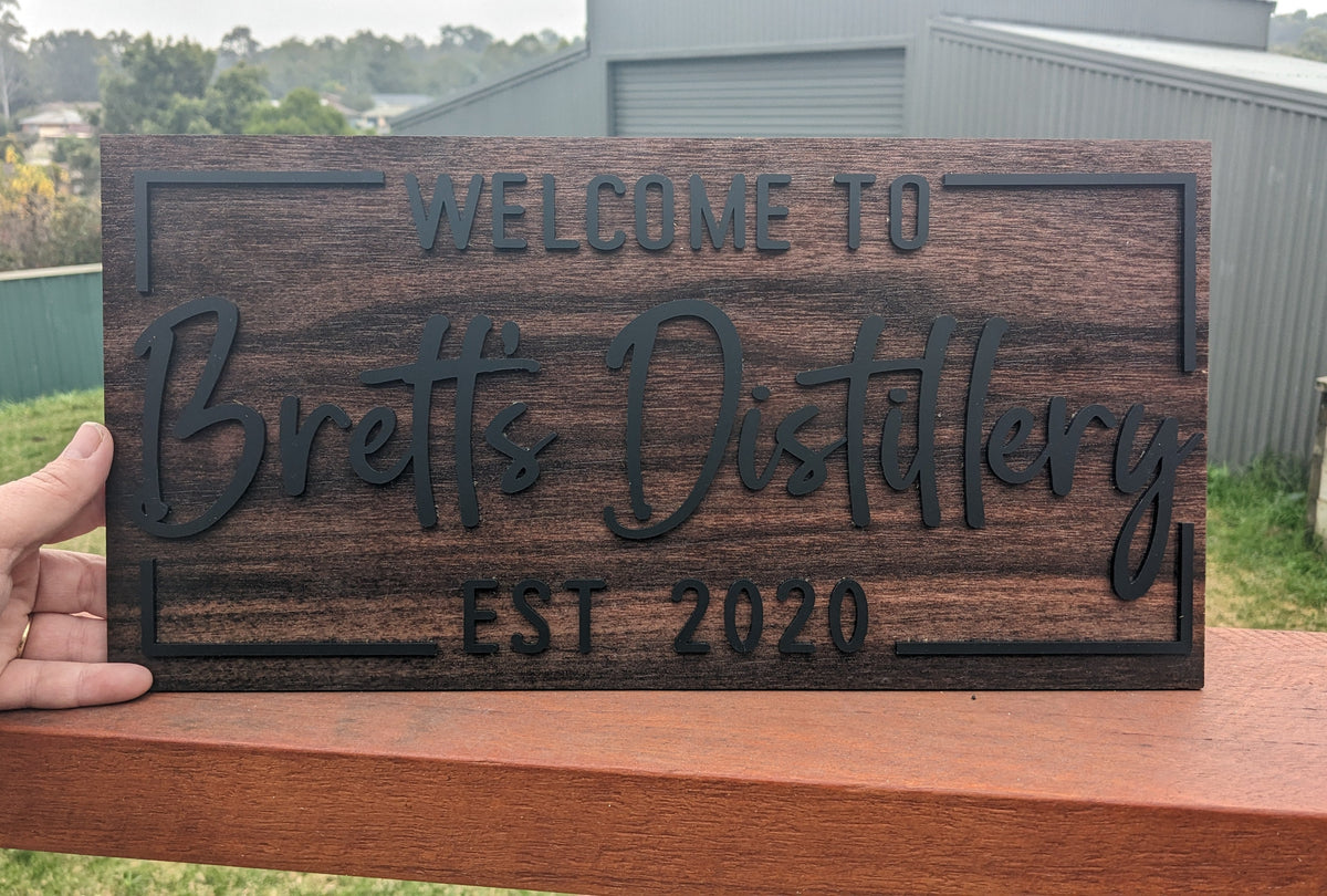 Welcome to Bretts Distillery wooden and black acrylic custom sign