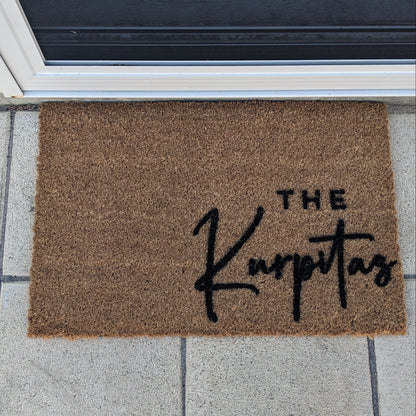 Custom Doormat with 'The Karpatas' text on a tiled floor outside a door. christmas gift idea