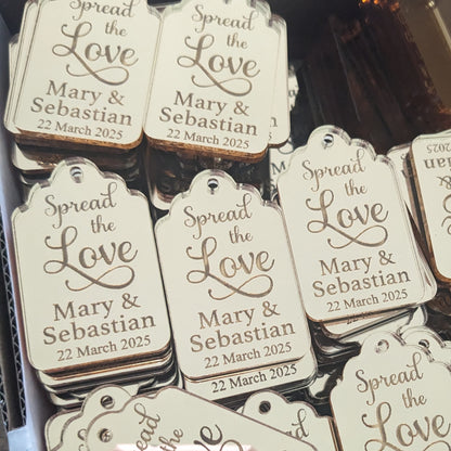 Personalized wedding favor tags with 'Spread the Love' text and names 'Mary & Sebastian'.
