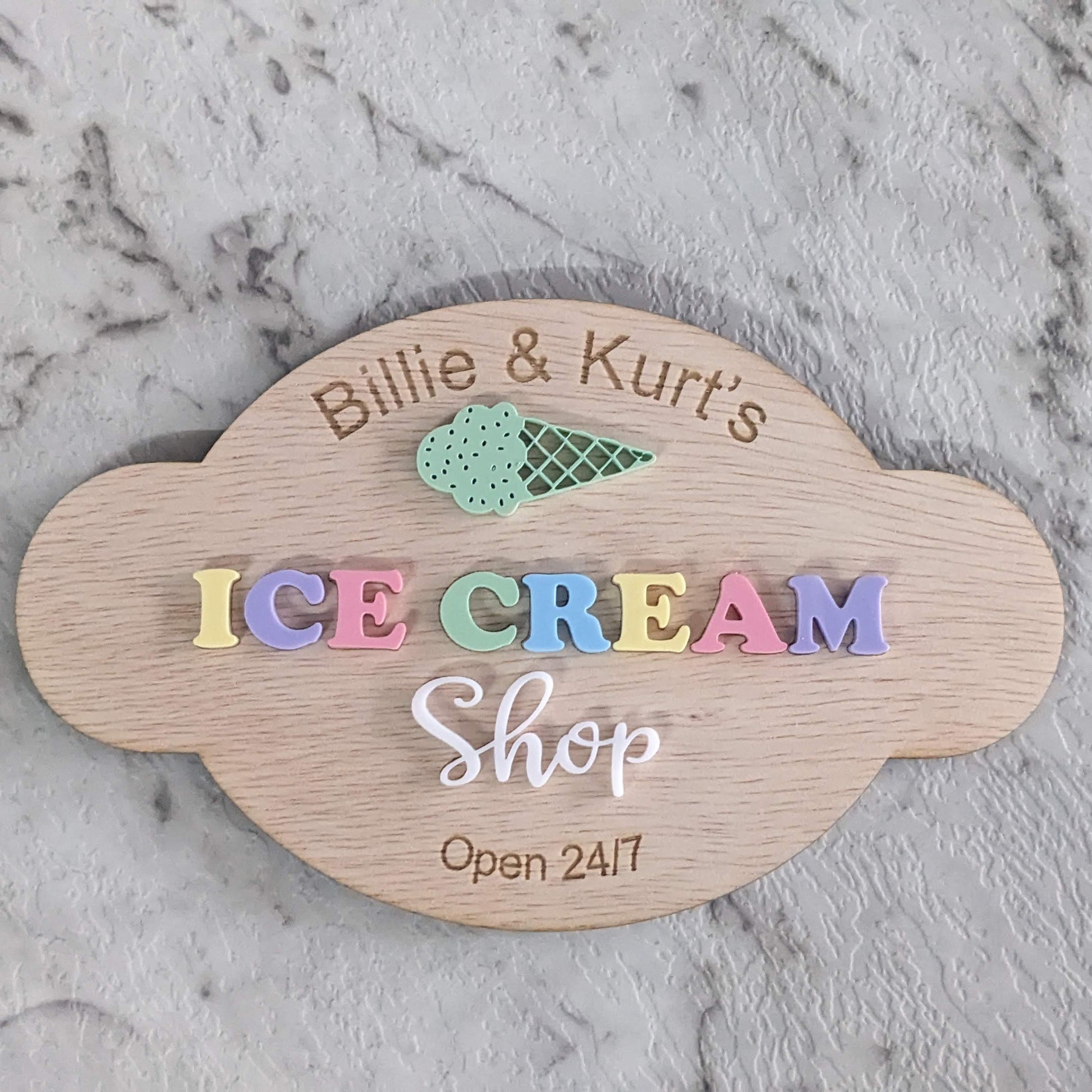 Custom Wooden sign for 'pretend play kitchen Ice Cream Shop' on a marble surface