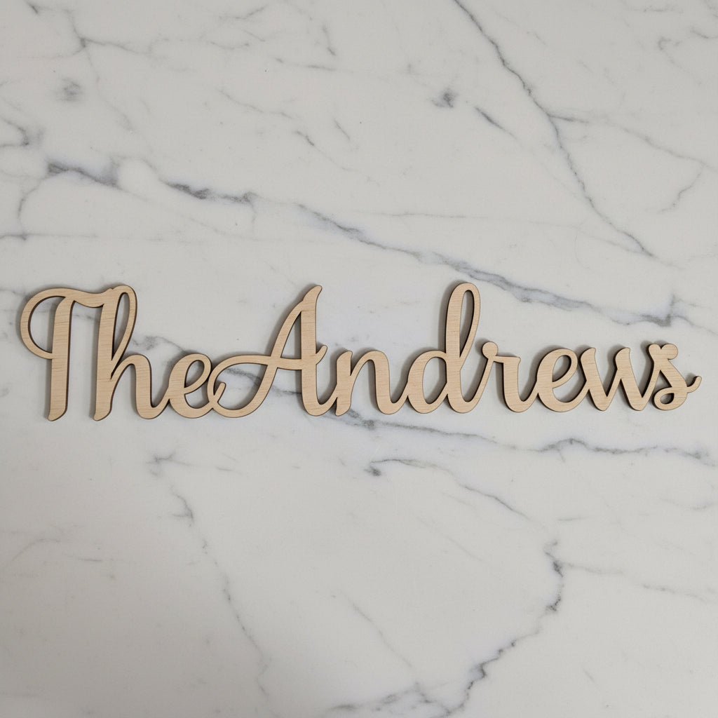 Personalised wooden name sign for a wedding, cut in script font from natural plywood