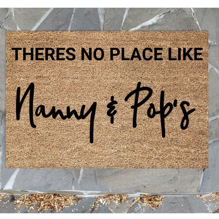personalised Doormat with text 'THERES NO PLACE LIKE Nanny & Pop's' on a stone floor background