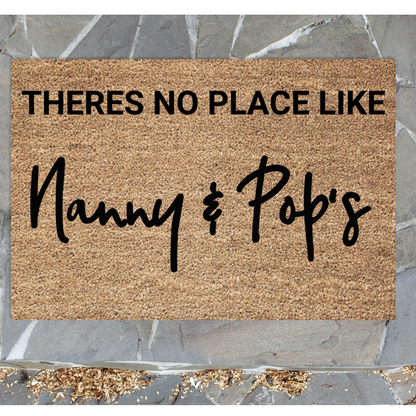 personalised Doormat with text 'THERES NO PLACE LIKE Nanny & Pop's' on a stone floor background