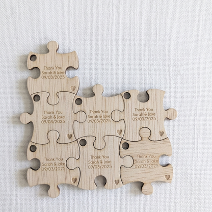 Wedding bonbomiere ideas, wooden puzzle pieces with engraved text on a light gray background
