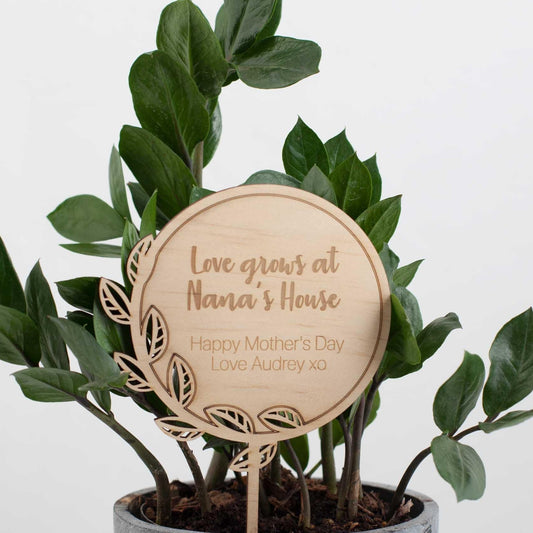 Personalised Love Grows Here plant stake in a pot plant