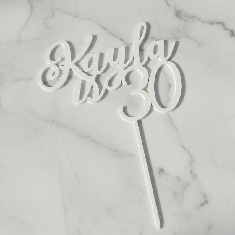 Personalised name and age acrylic cake topper in mirror gold on a birthday cake