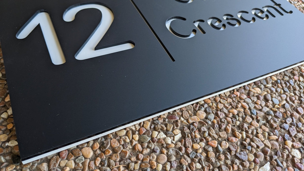 Custom acrylic house number sign mounted outside a home