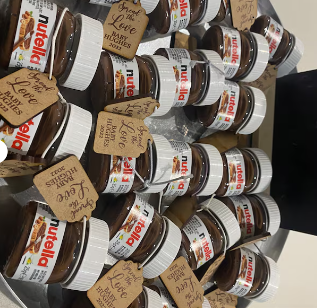 Multiple jars of Nutella with personalized tags on a shelf.